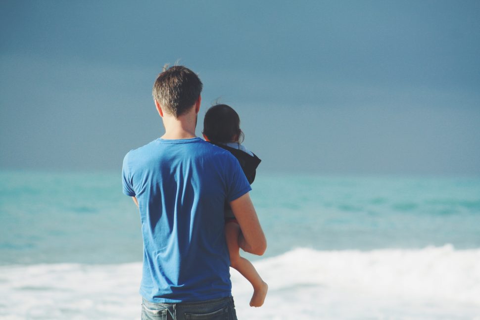 signs of autism man on beach with child