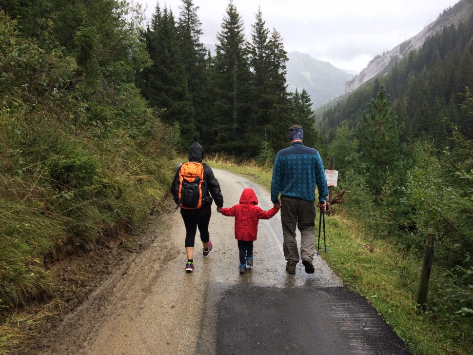 family walking down a road in the mountains for physical therapy