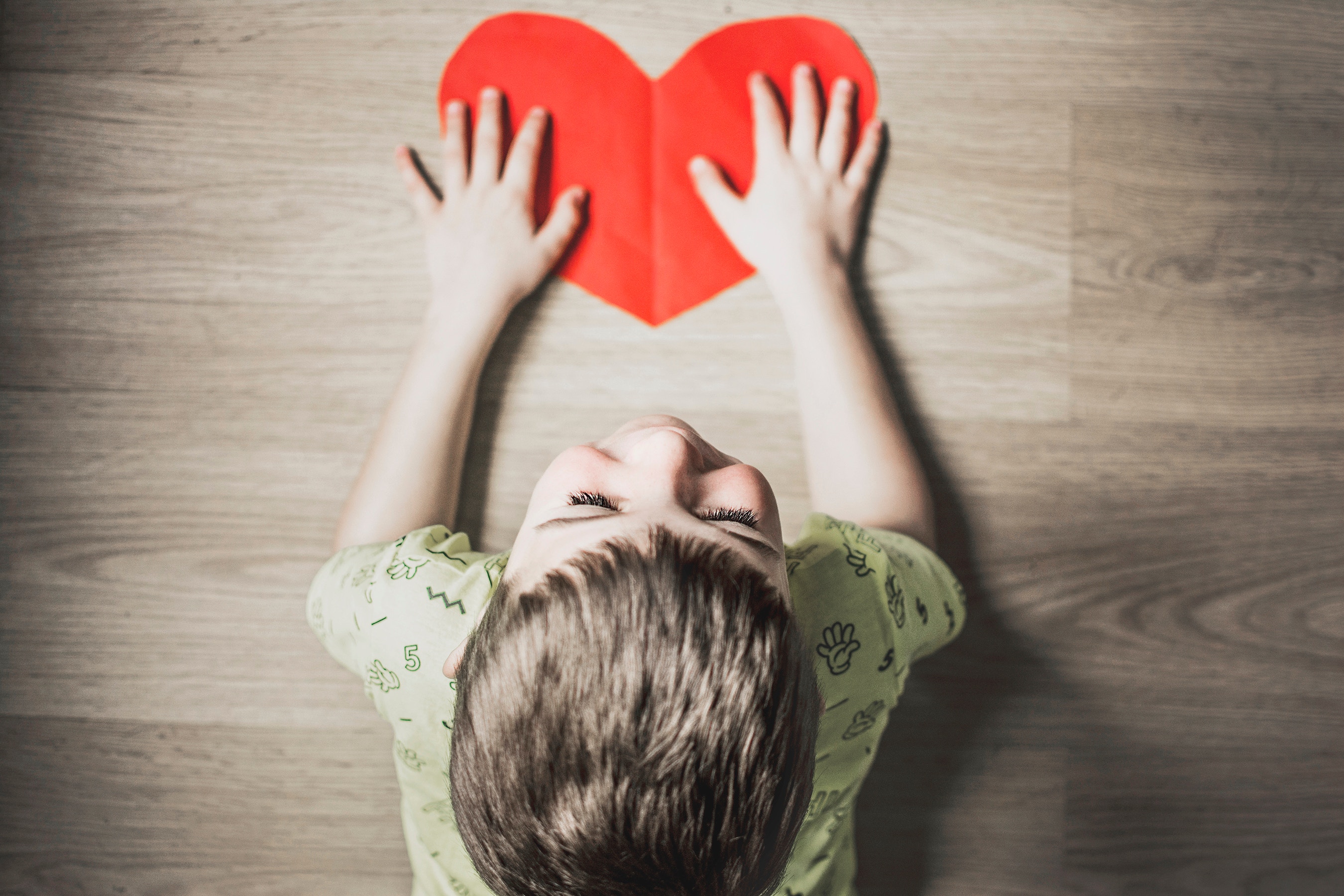 Child preventing bullying with a red heart